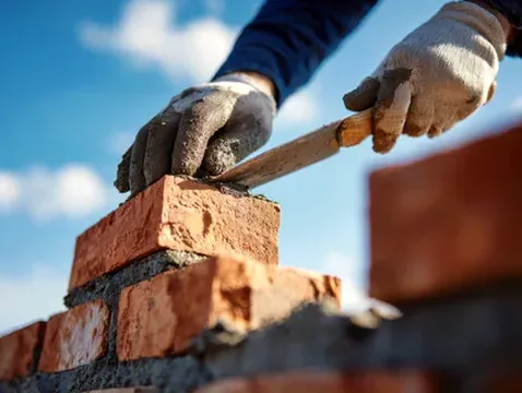 Mason laying masonry units in mortar on a Dublin, Ohio repair